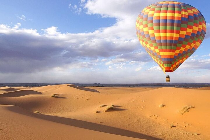 Soar above the serene desert landscape as the sun rises revealing the stunning oasis below. Experience the beauty of Dubai from a unique perspective in a hot air balloon.